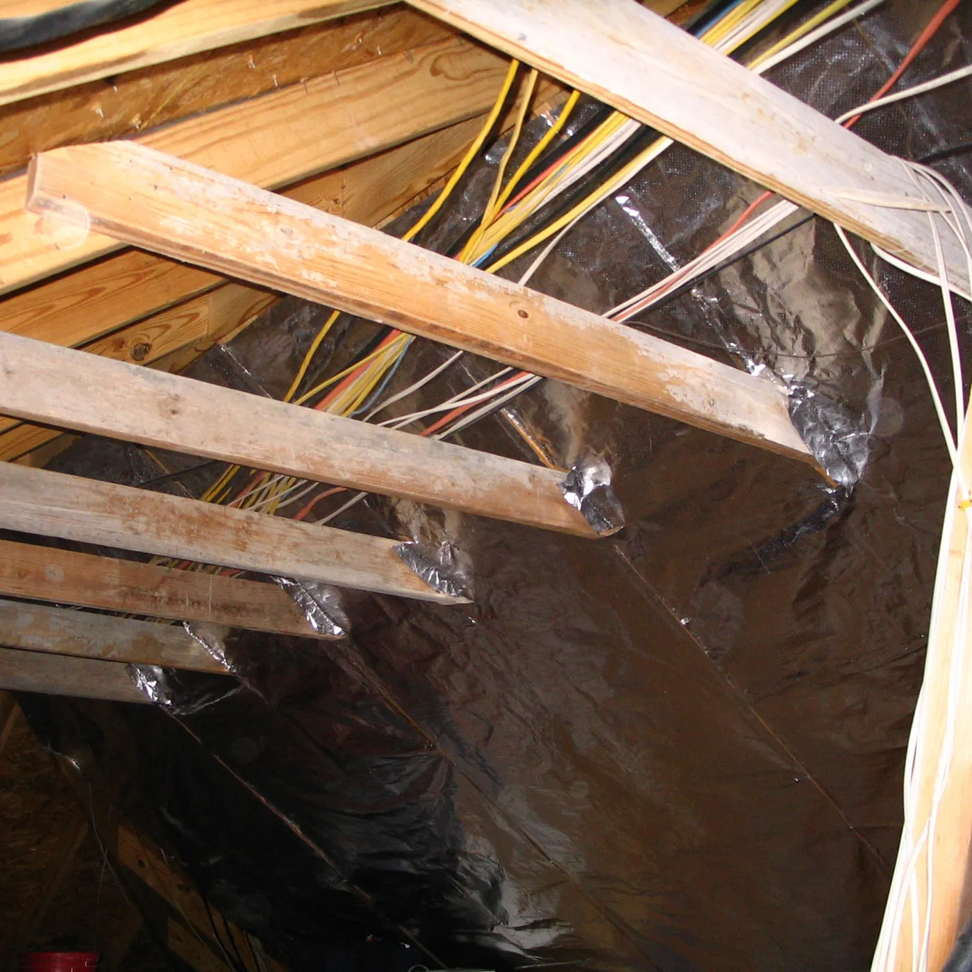 Ra-flect Laser Perforated radiant barrier installed beneath existing attic rafters